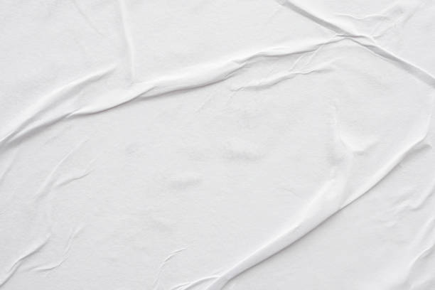 istock Blank white crumpled and creased paper poster texture background 1294958657