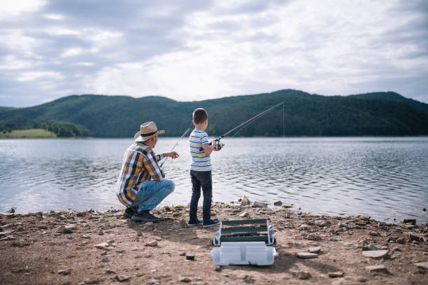istock Father teaching his son how to fishing. 1294958690