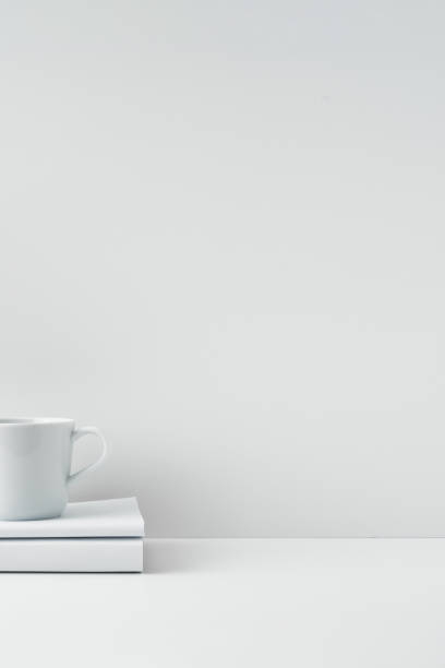 istock The mug stands on a stack of books on a white background. Natural and eco-friendly materials. Copy space, mock up. 1294959268