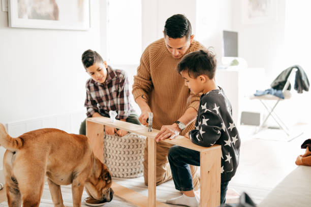 istock Dad working with kids at home on DIY project 1294959701
