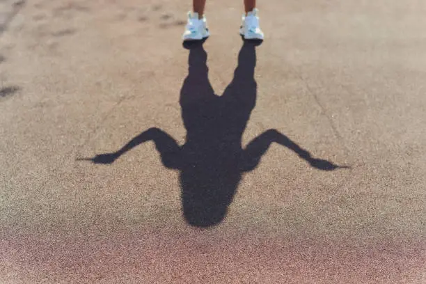 Photo of shadows of dates legs running outdoors