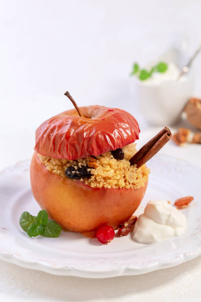 istock Baked spicy apple with couscous and dried berries. 1294961398