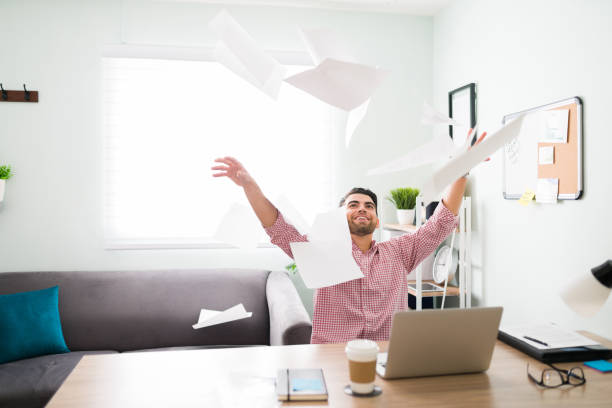 istock Smiling guy is celebrating the end of the work day 1294962914