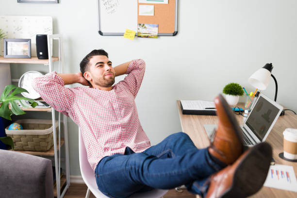 istock Good-looking man relaxing at his office desk 1294962936
