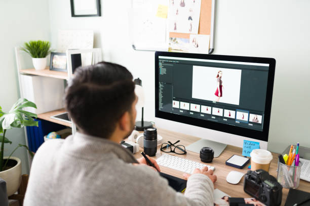 istock Young man at his desk and retouching some photos on the computer 1294963116