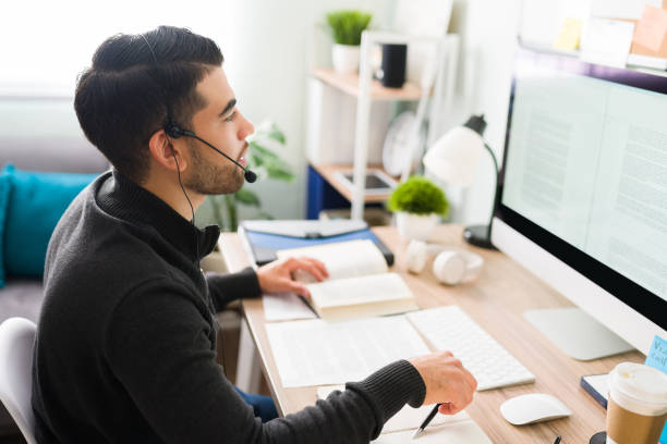 istock Hispanic translator working at his home office desk 1294963157