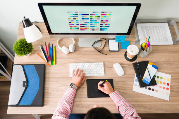 istock Top view of a graphic designer working at his office desk 1294963230