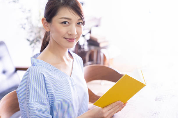 young attractive asian woman who reads a book