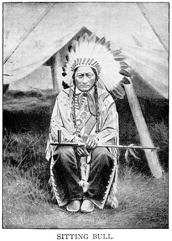 Halftone print of Sitting Bull, Hunkpapa Lakota chief, sitting with feather headress and peace pipe.