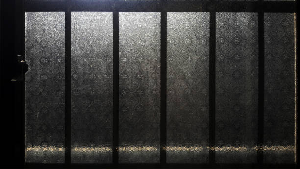 istock Patterned old glass windows, the morning sun shines in 1294971903