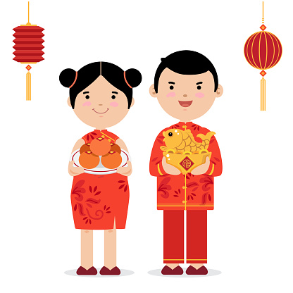 Cute chinese boy and girl in traditional suite holding goldenfish and a plate of orange for blessing.