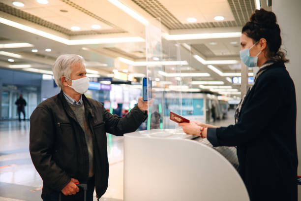 istock Senior man using a digital covid passport at the airport 1294981443