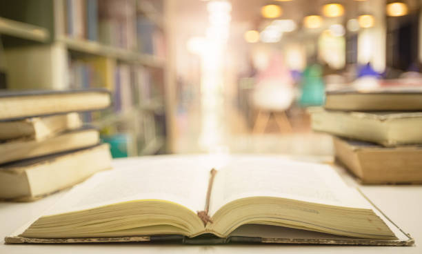 Open and reading old poetry books on blurred the library