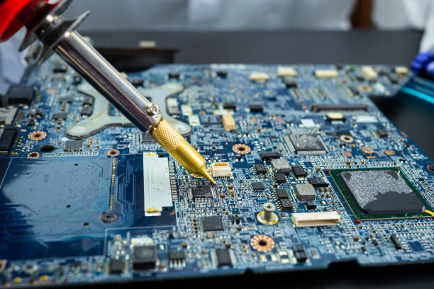 istock E-waste, technician repairing inside of hard disk by soldering iron. Integrated Circuit. the concept of data, hardware, technician and technology. 1294991084