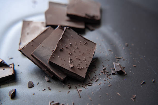 istock Delicious dark chocolate on black dish 1294991142