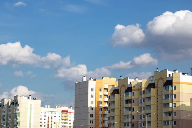 istock Blue sky and clouds above tall buildings 1294991894
