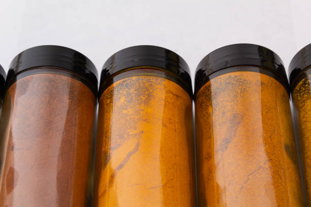 various bottles of spices for cooking on a white background