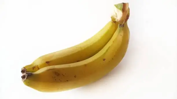 Photo of Cavendish bananas isolated on white background.