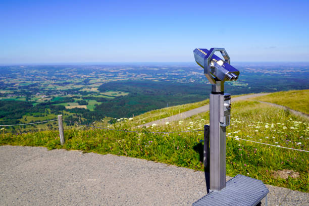 Looking at the puy de dome through binoculars in auvergne volcano site in France Looking at the puy de dome through binoculars in auvergne volcano site in France lens pas de calais stock pictures, royalty-free photos & images