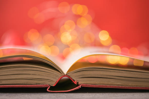 istock Book with lights on red background. Romantic Valentine  concept 1294996272