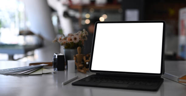 istock Graphic designer or photographer work station with tablet computer, camera and  color swatch at modern office. 1294996856