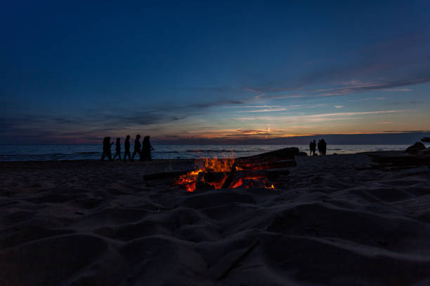 istock Unrecognisable people celebrating summer solstice with bonfires on beach 1294996919