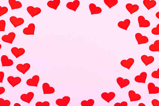 A card decorated with pattern red hearts, Valentine's Day. Celebration cards on pink background with copy space for your text. Banner.