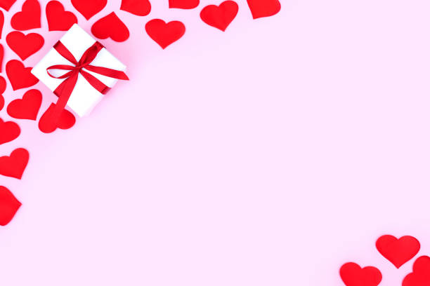 istock Background with gift and hearts with free space for text on pastel pink background. Flat lay, top view. Valentines day concept. Mother's Day concept. 1295002388