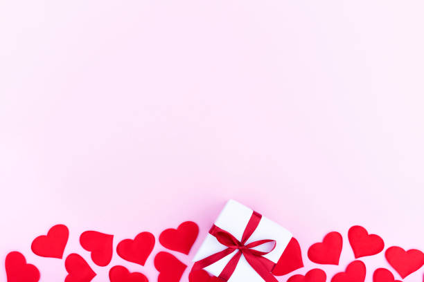 istock Background with gift and hearts with free space for text on pastel pink background. Flat lay, top view. Valentines day concept. Mother's Day concept. 1295002408