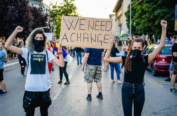 Young protestant women holding a poster with text 