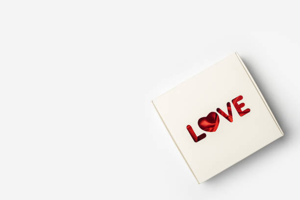 istock Gift box on a light white background. Composition Valentine's Day. Banner. Flat lay, top view 1295005209