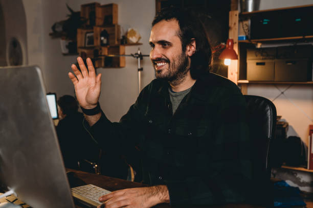 istock Millennial man is having a video call with a desktop pc in the office 1295007672