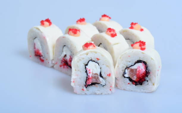 istock Colorful Japanese rolls with seafood and fish lie on a light background 1295009779