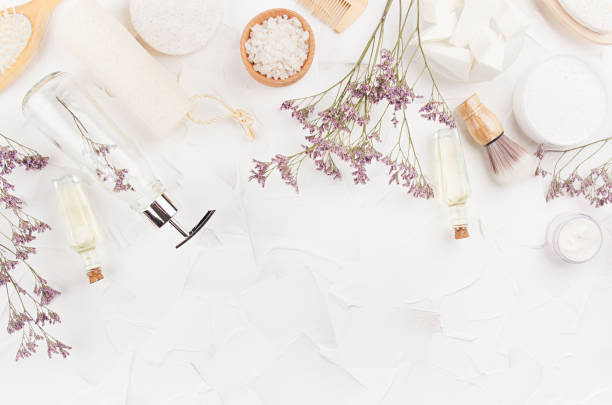 istock Soft light white and beige toiletry for bathroom with dry herbs on white plaster background, top view, copy space, border. 1295011273