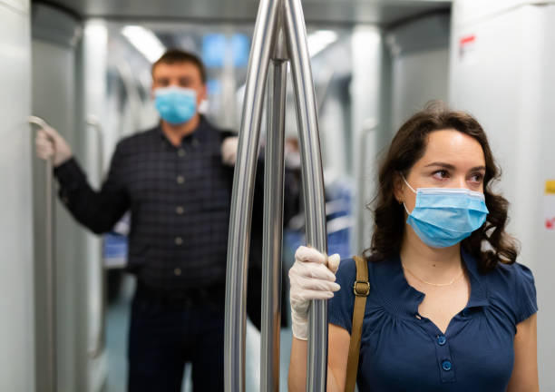 istock Brunette in medical mask in subway car 1295012672