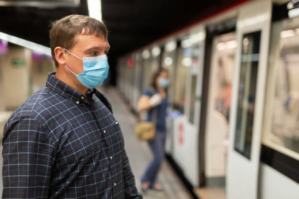 istock Man in medical mask on subway platform 1295012736