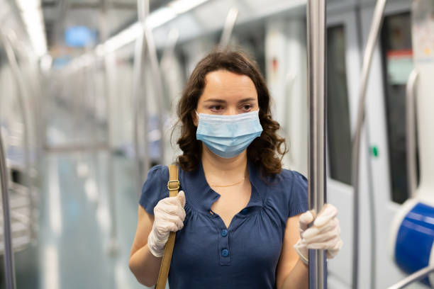 istock Woman in disposable mask in subway train 1295012745