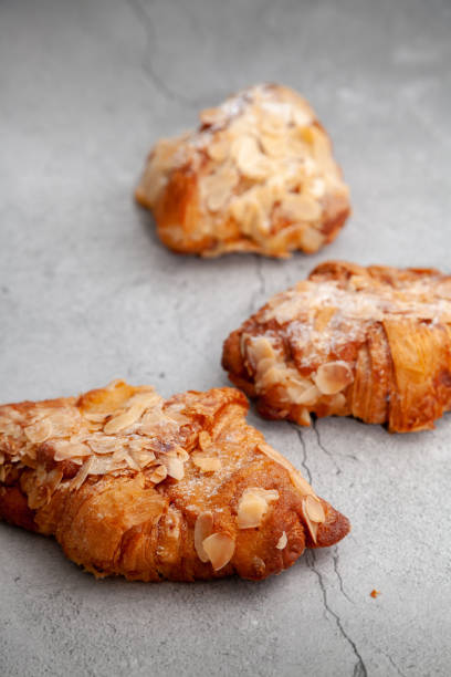 istock Fresh baked croissants on cement background 1295014829