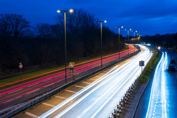 High angle view with long exposure of trails created by vehicle headlights and taillights travelling to and fro on London A3 thoroughfare.