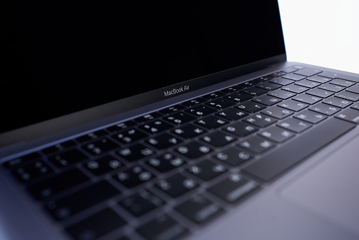 Minsk, Belarus - December 04 2020: a close up photo of a keyboard of a brand new Space Gray MacBook Air 2019, designed by Apple in California, assembled in China