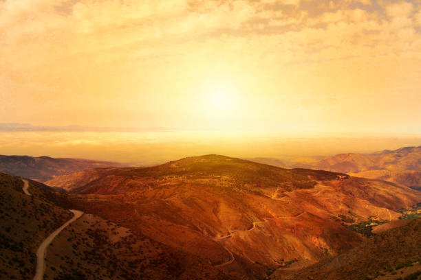 Image of the sunset between the moutains.This photo was taken in the atlas moutains in Morocco,the late evening in a rural area in the moutain.