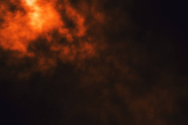 istock Red glowing smoke on dark background. 1295019319