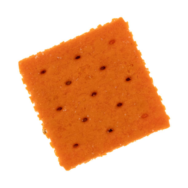 Cheese flavored small square crackers on a white background