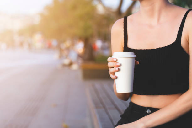 istock coffee in hand in white cardboard cup 1295021077