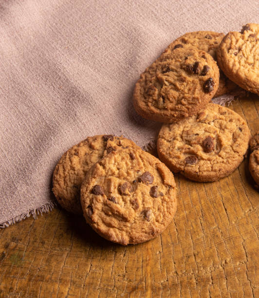 istock Cookies arranged on a rustic wooden surface with fabric, selective focus. 1295021734