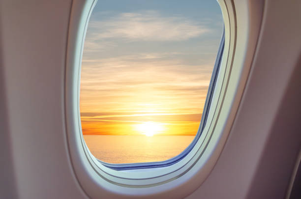 istock Airplane porthole view at sunset 1295022272