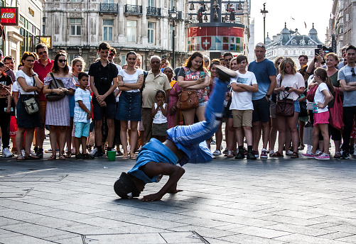 Summer in London. A street artist in the bustling Leicester Square in front of the multitude of different cultures and languages, united under the universal language of dance.