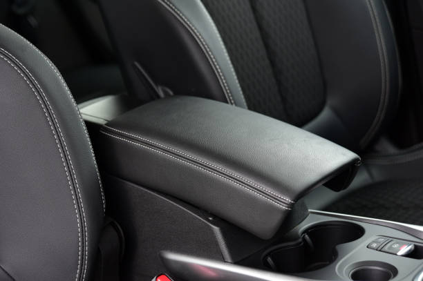 istock Armrest in the luxury passenger car between the front seats 1295024219