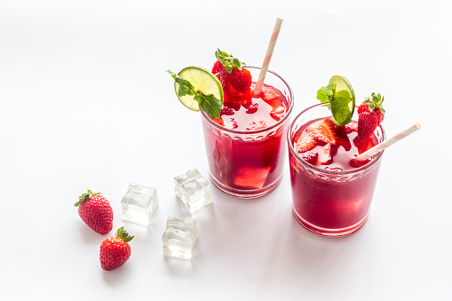 Strawberry cocktail or lemonade with ice and mint. Cold red drink.