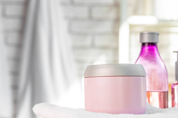 istock Cosmetic bottles against white bathroom wall background 1295027315